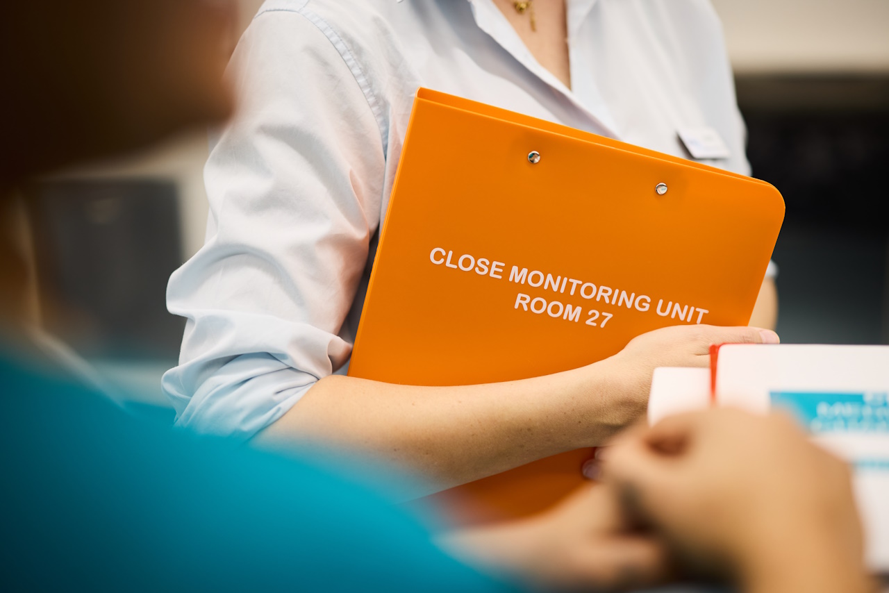 person holding documents | The George Centre